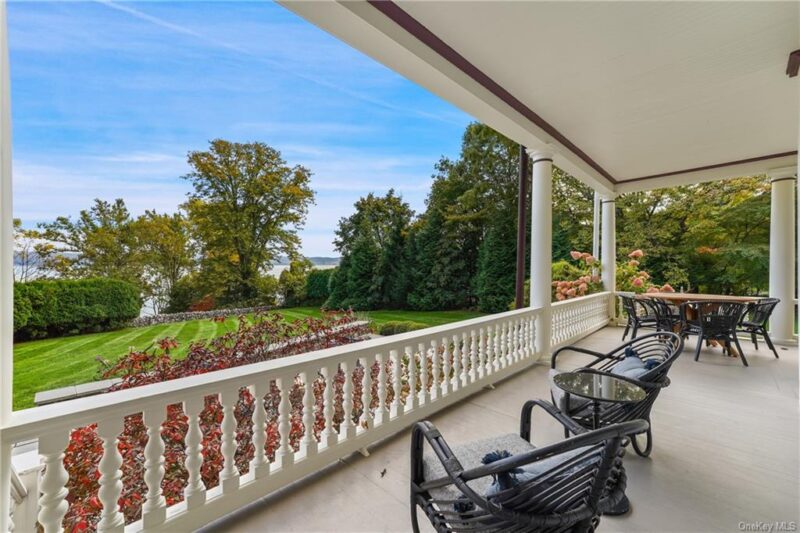 chairs on wraparound porch overlooking river view