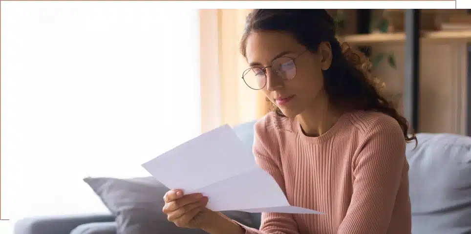 A woman reads a letter