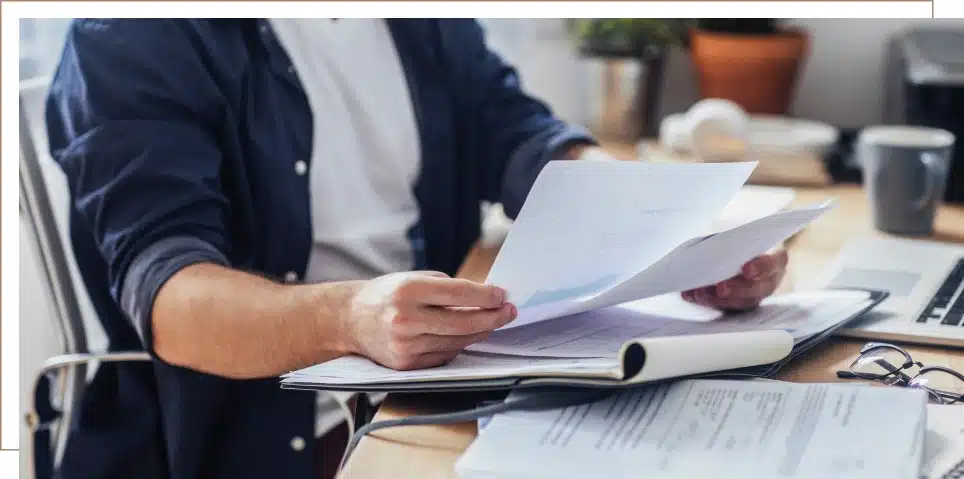 A close-up of documents as a person is reading them