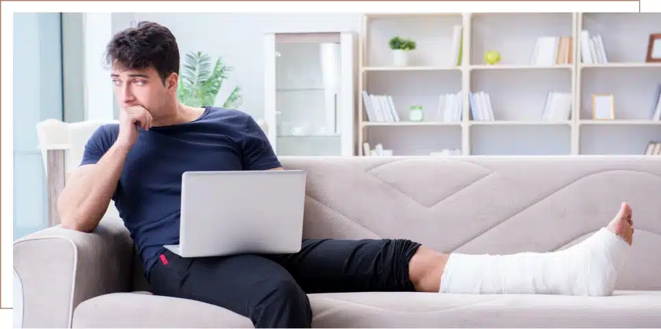 A person with an injury sitting on a couch