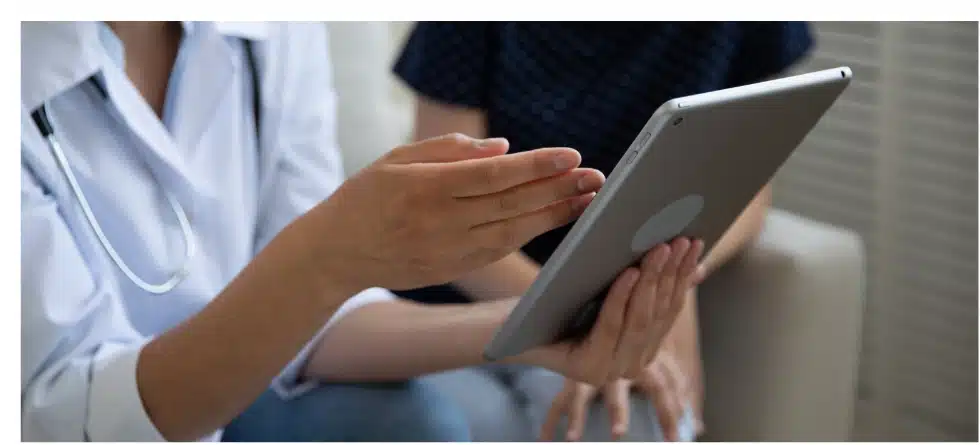 A close-up of two people discussing medical billing